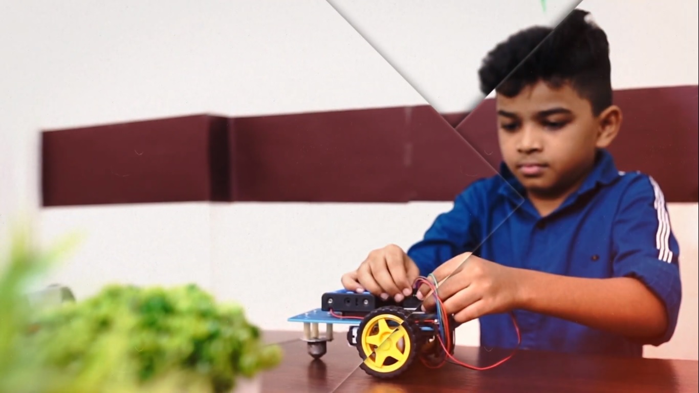 Young boy working on his robot model .
